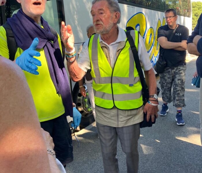 Two people in hi-vis are stood in conversation
