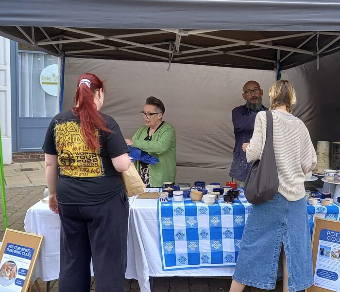 Two people approach a stall