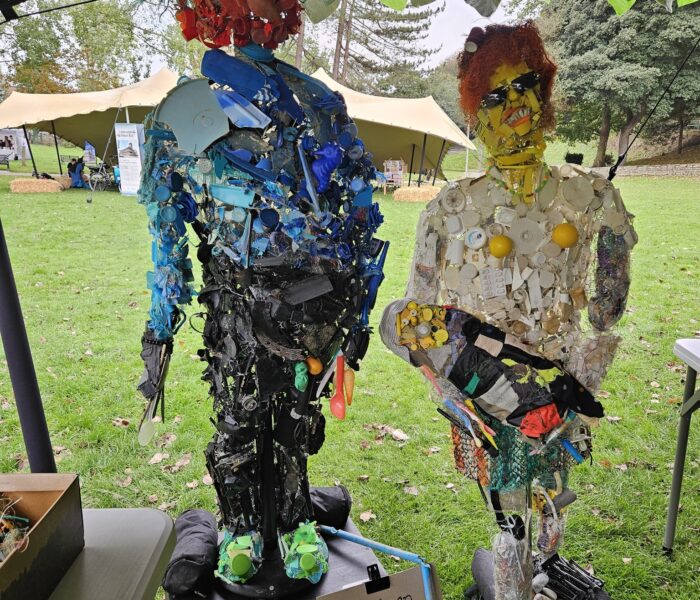 An image of two figures made out of recycled materials