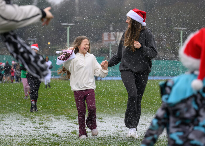 Two people running through fake snow