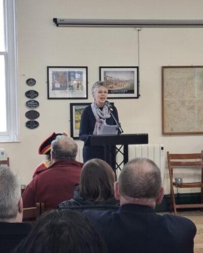 An image of a person standing at a lectern