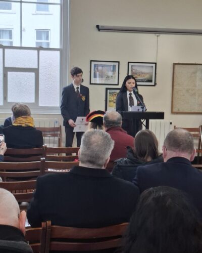Image of a person speaking at a lecturn