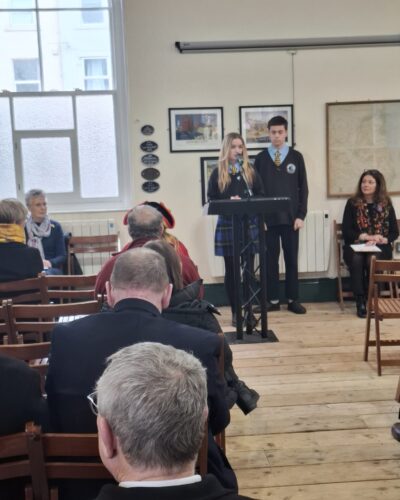 Image of a person speaking at a lecturn
