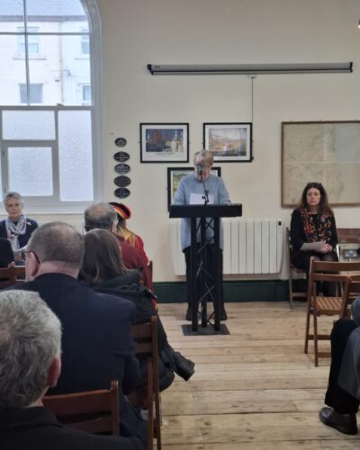 Image of a person speaking at a lecturn