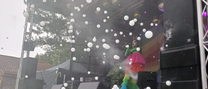 A performer on stage with a bubble machine running