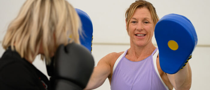 A person holding up boxing gloves